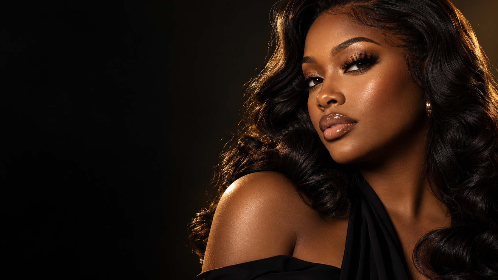 Black woman wearing beautifully defined lashes and bronze eye makeup